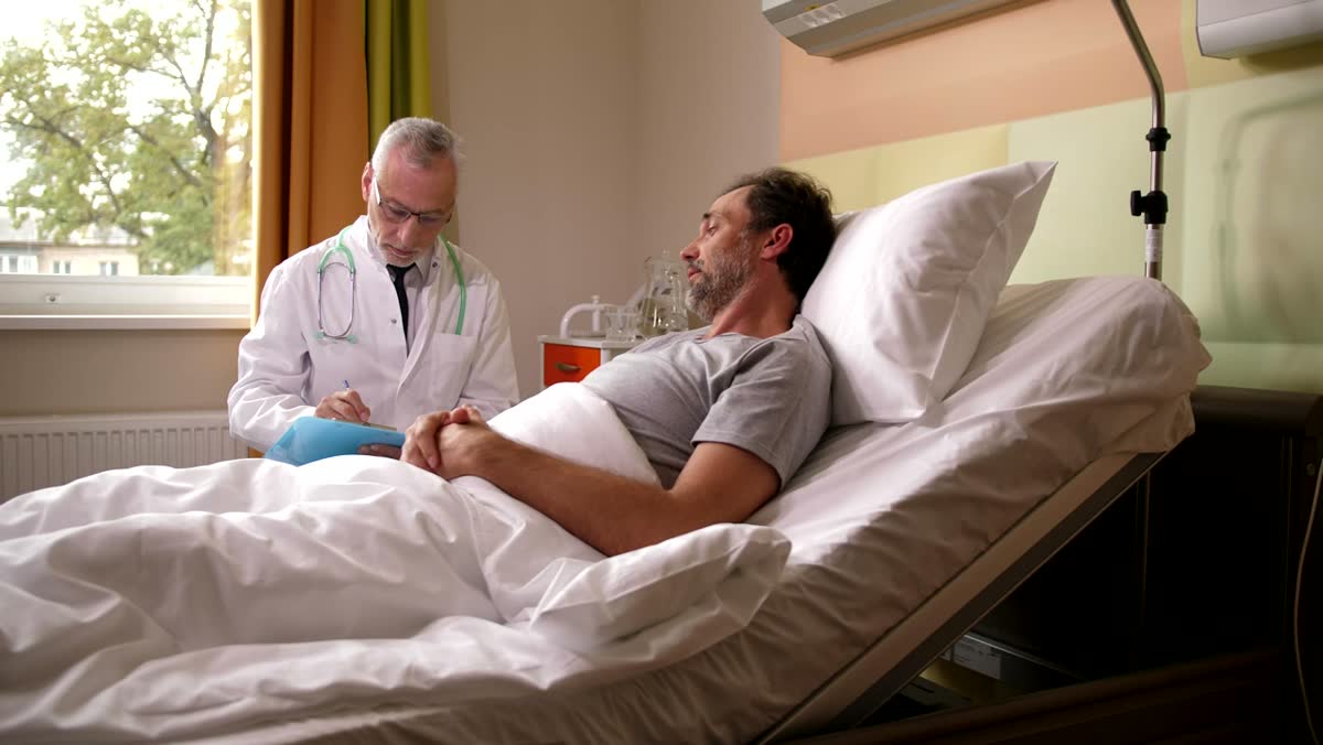 A doctor at a patient's hospital bedside
